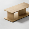 Minimalist wooden coffee table with a rectangular top, a matching rectangular base, and a central vertical support, set on a light, neutral background.