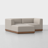 A modern, light beige L-shaped sectional sofa with low wooden base, set against a plain white background.