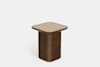 A small, modern side table with a square, beige tabletop and a rounded, rectangular wooden base against a plain white background.