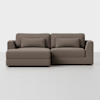 A modern brown sectional sofa with a chaise lounge on the left side, featuring two seat cushions, two back cushions, and two rectangular bolster pillows, set against a plain white background.