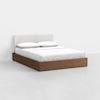 A modern bed with a white upholstered headboard, white bedding, and two pillows, featuring a wooden platform base, placed in a minimalistic, light-colored room.