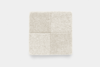 A square, cream-colored textured fabric sample divided into four equal sections, each with a slightly different shade and texture, placed on a plain white background.