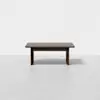 A modern, rectangular wooden table with a dark brown finish is centered against a plain white background. The table has simple, clean lines and sturdy legs.