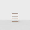 A minimalist wooden bookshelf with three open shelves stands alone on a light gray floor against a plain white background.
