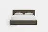 A modern, dark brown upholstered bed with a tall headboard, white bedding, and two white pillows, set against a plain white background.