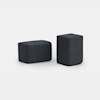 Two black rectangular fabric ottomans, one positioned horizontally and the other vertically, set against a plain white background.