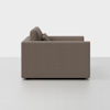 Side view of a modern, boxy, brown upholstered sofa with straight arms and two back cushions, set against a plain white background.