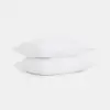Two white pillows stacked on top of each other against a plain white background.