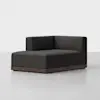 A modern, dark gray corner sofa chair with clean lines, a low wooden base, and an armless design on one side, set against a plain white background.