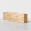 A long, light wood dresser with a minimalist design featuring clean lines and multiple horizontal drawers, set against a plain white background.