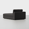 A modern, dark gray chaise lounge with a low backrest and clean lines, positioned on a light gray floor against a plain white background.