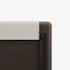 Close-up of the corner of a bed frame with a dark wood finish and an upholstered beige fabric headboard on a white background.