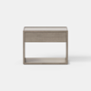A modern, light wood nightstand with a single drawer and an open shelf below, set against a plain white background.