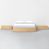 A bed with two wooden boxes.