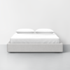 A modern, minimalist bed with a light gray upholstered base, white sheets, and two white pillows, set against a plain white wall and floor.