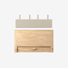 A wooden headboard with a light wood finish is placed below a rectangular, beige fabric panel with four mounting brackets against a plain white background.