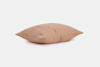 A rectangular, light brown textured pillow with visible seams is shown against a plain white background.