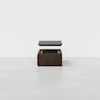 A dark wooden box with its lid hovering above, shown against a plain white background on a light gray floor.