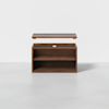 A wooden box with an open lid, revealing a hollow interior and a middle shelf, set against a plain white background.