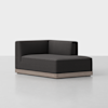 A modern, dark gray upholstered corner sofa with clean lines and a low, light wood base, set against a plain white background.
