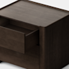 A dark wooden square nightstand with rounded edges and a single drawer partially open, placed on a white floor against a plain white background.