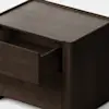 A dark wooden square nightstand with rounded edges and a single drawer partially open, placed on a white floor against a plain white background.