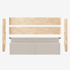 Disassembled light wood bed frame with two side rails, two end panels, and a padded beige headboard, all laid out on a white background.