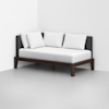 Modern minimalist daybed with a dark wooden frame, gray upholstered backrest, and three large white pillows, placed in the corner of a white room with a light gray floor.