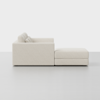 A modern, light beige sectional sofa with thick cushions and an attached chaise lounge, shown from the side against a plain white background.