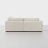 A modern, light beige sectional sofa seen from the side, with clean lines and plush cushions, set against a plain white background.