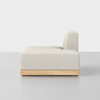 A modern, minimalist armless beige sofa module with a wooden base, shown in side view against a plain white and gray background.