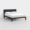 A modern bed with a dark wooden frame, low legs, a black upholstered headboard, and white bedding with two pillows, set in a minimalistic, light-colored room.