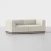 A modern, off-white upholstered loveseat with clean lines and a thick wooden base, set against a plain light gray background.