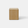 A light wood nightstand with a modern, minimalist design, featuring a single drawer that is partially open and smooth, clean lines against a plain white background.