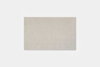 Rectangular beige area rug with a soft, smooth texture, placed on a plain white background.