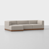 A modern beige sectional sofa with clean lines, low backrests, and a wooden base, arranged in an L-shape on a plain light gray floor against a white background.