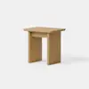 Minimalist wooden side table with a rectangular top and two wide, flat legs on either side, positioned against a plain white background.
