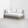 A modern daybed with a light wood base, upholstered gray back and side panels, and four white pillows, placed in the corner of a minimalist white room.
