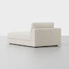 A modern, cream-colored upholstered chaise lounge with a low backrest and armrest on one side, set against a plain white background.