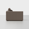 A side view of a modern, boxy, brown upholstered sofa with clean lines, set against a plain white background.
