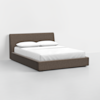 A modern platform bed with a low-profile, upholstered frame in gray fabric, featuring a slightly angled headboard and dressed with white bedding and two white pillows, set against a plain white background.