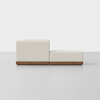 A modern, minimalist cream-colored sofa with a wooden base, shown from the side against a plain white background. The sofa has clean lines and a low-profile design.