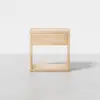 A modern, light wood nightstand with an open base, rectangular frame, and a single drawer in the center, photographed against a plain white background.