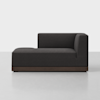 A modern, dark gray upholstered chaise lounge with a wooden base, featuring a right-side armrest and backrest, set against a plain white background.