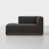 A modern, dark gray upholstered chaise lounge with a wooden base, featuring a right-side armrest and backrest, set against a plain white background.