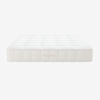 A white, rectangular mattress with a quilted, tufted surface and the brand name THUMA embroidered on the side, shown against a plain white background.