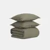 Two olive green pillows are stacked on top of a neatly folded matching olive green duvet, all made from a smooth, soft-looking fabric, set against a plain white background.