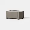 A small, rectangular wooden table with a minimalist design and light brown finish, set against a plain white background.