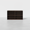 A dark brown wooden bookshelf with eight open shelves, arranged in two columns and four rows, standing on a light gray floor against a plain white background.