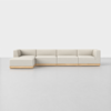 A modern, minimalist L-shaped sectional sofa with light beige upholstery and a wooden base, set against a plain white background.